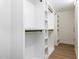 A sizable walk-in closet with built-in shelving and wooden floors offers organization and storage space at 3009 Hillmer Dr, Raleigh, NC 27609