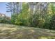 Expansive backyard bordered by lush greenery, perfect for relaxation at 311 Alamosa Pl, Cary, NC 27519