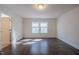 Spacious bedroom featuring hardwood floors and double window at 311 Alamosa Pl, Cary, NC 27519
