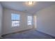 Bedroom with carpeted floor features two windows that provide a view of the neighborhood streetscape at 311 Alamosa Pl, Cary, NC 27519