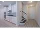 Inviting entryway with stairs, and a view into the modern kitchen at 311 Alamosa Pl, Cary, NC 27519