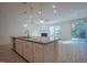 Modern kitchen island overlooks open plan living room, stainless appliances, and granite counter tops at 311 Alamosa Pl, Cary, NC 27519