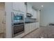 Modern kitchen features granite countertops, stainless appliances and white cabinets at 311 Alamosa Pl, Cary, NC 27519
