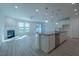 Bright living space with modern floors, fireplace, and sliding glass doors to the backyard at 311 Alamosa Pl, Cary, NC 27519