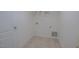 A compact utility room or closet features a tile floor with visible plumbing and electrical connections at 311 Alamosa Pl, Cary, NC 27519
