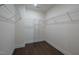 Spacious walk-in closet with multiple shelves and hanging rods for optimal storage and organization at 311 Alamosa Pl, Cary, NC 27519
