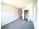 A carpeted bedroom with an open closet and neutral walls at 327 Bishop Ln, Sanford, NC 27330