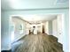 Spacious open-concept room view into modern kitchen, white cabinets, and stainless steel appliances at 327 Bishop Ln, Sanford, NC 27330