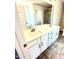 Bathroom vanity with double sinks, white cabinets, bronze fixtures and tiled floors at 332 Bishop Ln, Sanford, NC 27330