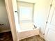 Bathroom with a soaking tub under a window and stylish tile flooring at 332 Bishop Ln, Sanford, NC 27330