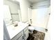 Well-lit bathroom features a shower-tub combo with bronze fixtures and a single sink vanity on a hard surface floor at 332 Bishop Ln, Sanford, NC 27330
