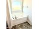 A new bathtub has stylish faucet hardware and is set in front of a window at 332 Bishop Ln, Sanford, NC 27330