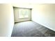 Bedroom with gray carpet, neutral paint, and large window that provides natural light at 332 Bishop Ln, Sanford, NC 27330