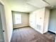 Carpeted bedroom with a window, closet, and neutral colored walls at 332 Bishop Ln, Sanford, NC 27330