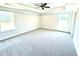 Bright Primary bedroom with large windows and a tray ceiling with fan at 332 Bishop Ln, Sanford, NC 27330