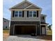Two-story home with a two-car garage and gray siding at 332 Bishop Ln, Sanford, NC 27330