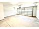 Clean, empty two-car garage featuring white walls and a concrete floor at 332 Bishop Ln, Sanford, NC 27330