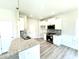 Modern kitchen featuring granite countertops, stainless steel appliances, and white cabinets at 332 Bishop Ln, Sanford, NC 27330