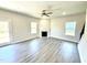 Bright living room features a fireplace, large windows, and laminate flooring at 332 Bishop Ln, Sanford, NC 27330