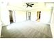 Bright main bedroom with neutral carpet, trey ceiling with fan, and doorways to bath and closet at 332 Bishop Ln, Sanford, NC 27330