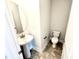 Clean powder room with stylish pedestal sink and a modern toilet at 332 Bishop Ln, Sanford, NC 27330
