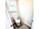 Powder room with toilet, tiled flooring, base trim, and window at 332 Bishop Ln, Sanford, NC 27330