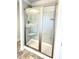 Bathroom shower with sliding glass doors, showerhead, tiled walls and base at 332 Bishop Ln, Sanford, NC 27330