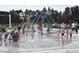 Children and adults playing and enjoying the splash pad with water features at 332 Bishop Ln, Sanford, NC 27330