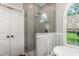 Modern bathroom with glass shower, white accents, and a soaking tub at 3440 Black Bear Cv, Burlington, NC 27215
