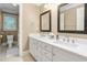 Bathroom with double sink vanity, framed mirrors, white cabinets, and granite countertop at 3440 Black Bear Cv, Burlington, NC 27215