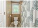Cozy powder room featuring a toilet with a patterned shower curtain, a small window, and neutral wall color at 3440 Black Bear Cv, Burlington, NC 27215