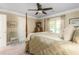 Serene bedroom showcasing a four-poster bed, neutral color palette, and a window with a view to the outdoors at 3440 Black Bear Cv, Burlington, NC 27215
