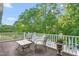 Inviting deck with comfortable seating and serene views of lush greenery and a refreshing swimming pool at 3440 Black Bear Cv, Burlington, NC 27215