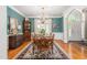 Dining room featuring a wooden table, a china cabinet, and a large window offering natural light at 3440 Black Bear Cv, Burlington, NC 27215