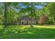 Well-maintained home nestled among mature trees and greenery at 3440 Black Bear Cv, Burlington, NC 27215