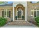 Inviting brick home featuring a decorative front door, arched transom, and columns at 3440 Black Bear Cv, Burlington, NC 27215