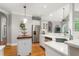 Bright kitchen with white countertops, stainless steel appliances, and hardwood floors at 3440 Black Bear Cv, Burlington, NC 27215