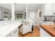 Kitchen with white cabinets, stainless steel dishwasher, and an island with a wooden countertop at 3440 Black Bear Cv, Burlington, NC 27215