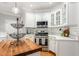 Well-lit kitchen featuring stainless steel appliances, tile backsplash, and a butcher block island at 3440 Black Bear Cv, Burlington, NC 27215