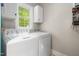 Well-lit laundry room featuring a washer, dryer, and storage cabinets at 3440 Black Bear Cv, Burlington, NC 27215