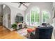 Bright living room with stone fireplace, vaulted ceiling and large windows at 3440 Black Bear Cv, Burlington, NC 27215