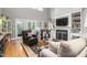Bright living room featuring soaring ceilings, a fireplace with built-ins, and two leather armchairs at 3440 Black Bear Cv, Burlington, NC 27215