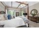 Spacious bedroom featuring neutral tones, dark wood furniture and double doors at 3440 Black Bear Cv, Burlington, NC 27215
