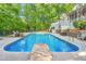 Sparkling in-ground pool with diving rock surrounded by landscaped yard and a charming two-story home at 3440 Black Bear Cv, Burlington, NC 27215