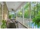 Relaxing screened-in porch with comfortable seating, ceiling fan, and view of the pool and wooded backyard at 3440 Black Bear Cv, Burlington, NC 27215