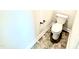 Toilet room featuring a toilet, tile floor, and a wall-mounted toilet paper holder at 356 Bishop Ln, Sanford, NC 27330