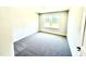 This bedroom features neutral walls and carpet, and a view to the outdoors at 356 Bishop Ln, Sanford, NC 27330