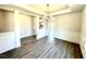 Dining room showcasing wainscoting, modern chandelier, and an open floor plan at 356 Bishop Ln, Sanford, NC 27330