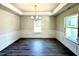 Dining room featuring wood-look flooring, white wainscoting, and decorative lighting at 356 Bishop Ln, Sanford, NC 27330