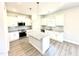 Kitchen with stainless appliances, granite countertops, white cabinets, and a center island at 356 Bishop Ln, Sanford, NC 27330